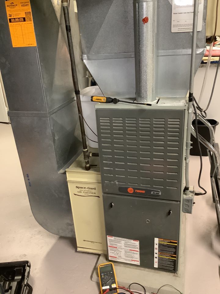 An interior view of a room with a furnace and a heater