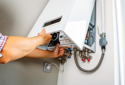 A professional technician repairing a water heater